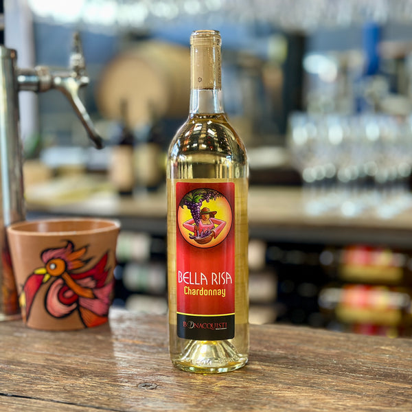 A bottle of Bella Risa Chardonnay from Bonacquisti Wine Company sitting on the bar with a hand painted flower pot from Daniel Luna