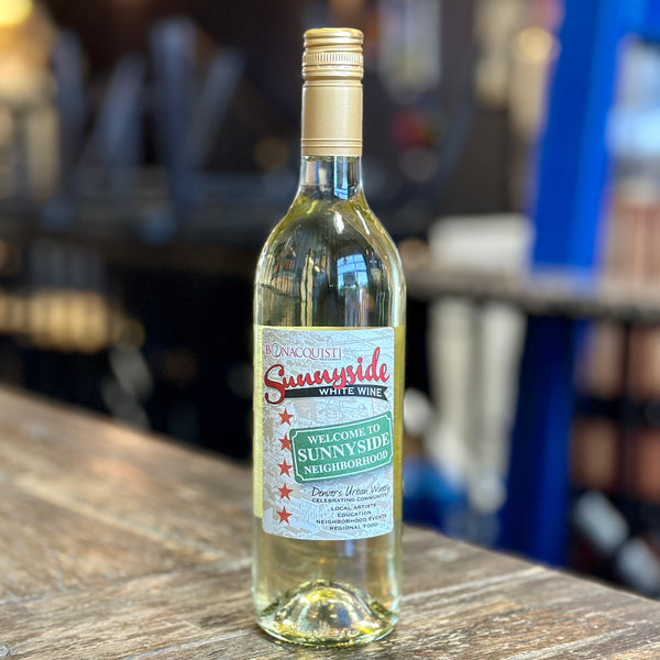 A bottle of Bonacquisti Sunnyside White Wine sitting on the counter.