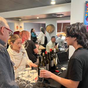 A customer choosing her wine at Bonacquisti Wine Company