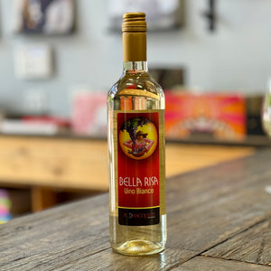 Bottle of Bella Risa Vino Bianco from Bonacquisti Wine Co. on a wooden table with a blurred background