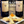 Bonacquisti Wine bottles with labels and a plate of cheese on a wooden surface, promoting a wine and cheese class event August 21, 6p.