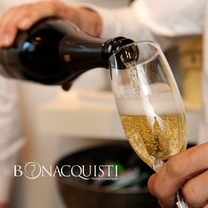 Someone pouring a glass of sparkling wine at Bonacquisti Wine Company